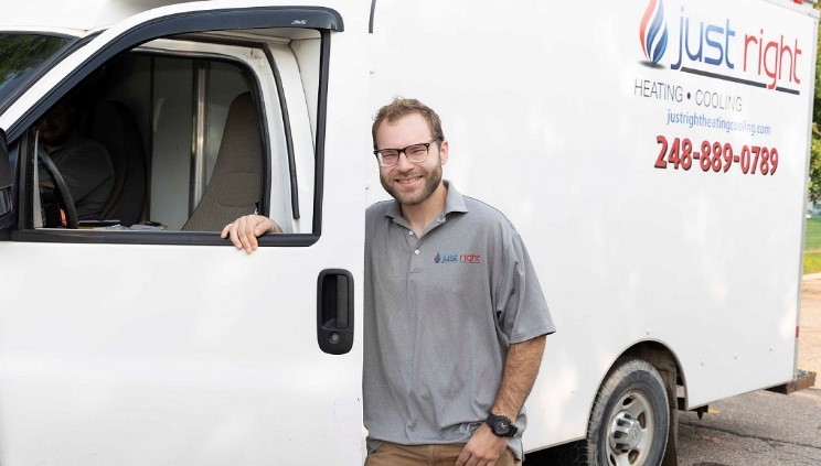 Boiler repair technician standing in front of Just Right Heating & Cooling service van